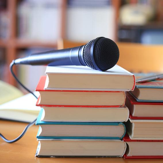 microphone sitting on a pile of books