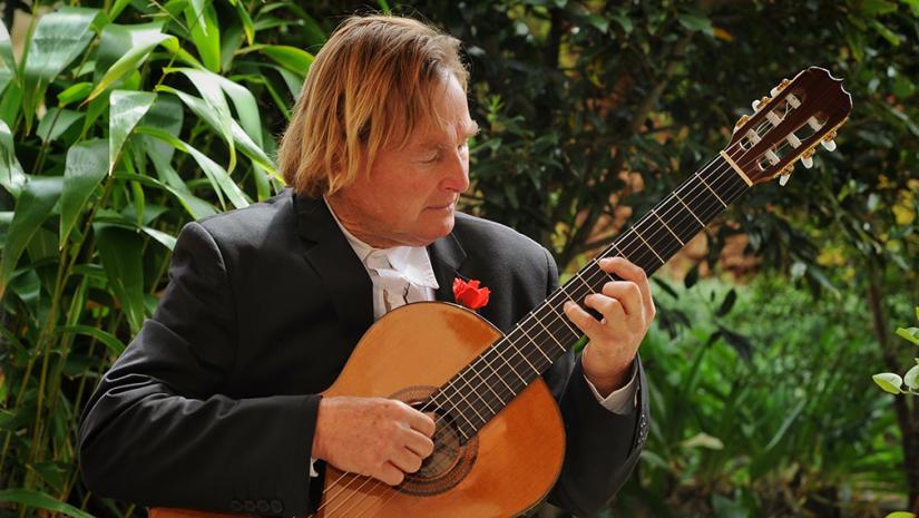 Phil Moore playing his guitar