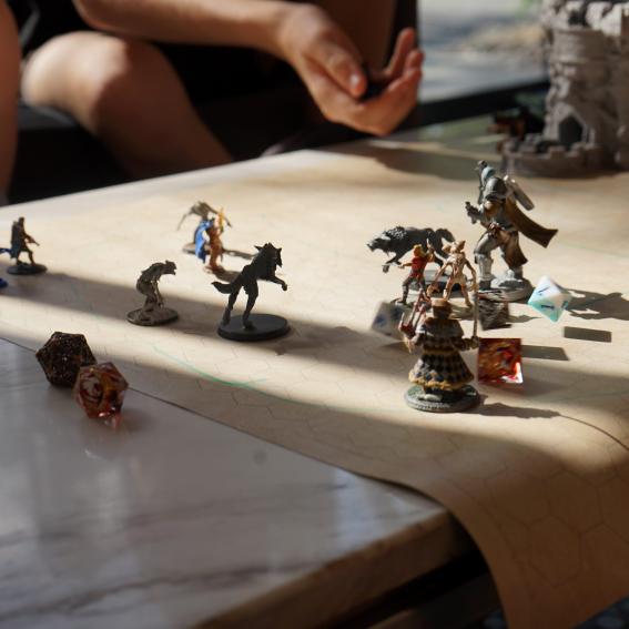 Miniatures on a square map with Dungeons and Dragons dice.