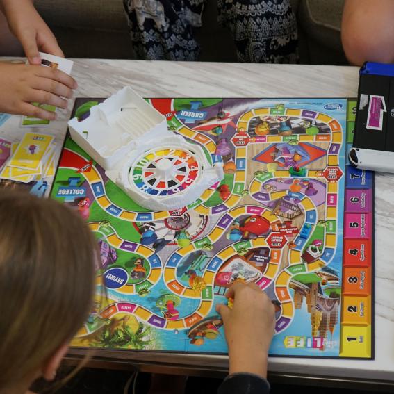 Some young people playing the Game of Life.