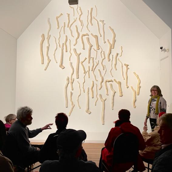 People viewing the artwork Angophora by Yasmin Smith.