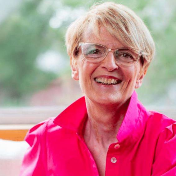 Headshot of Anne Gately in a pink blouse.