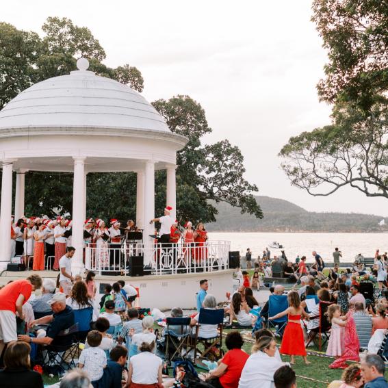 Balmoral Rotunda, a white done with a Choir and band singing on it in front of a large crowd.