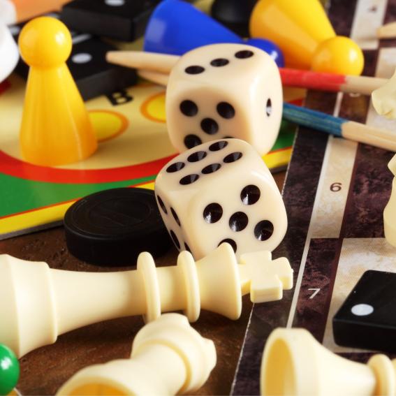 Colourful board game pieces and dice on a table.