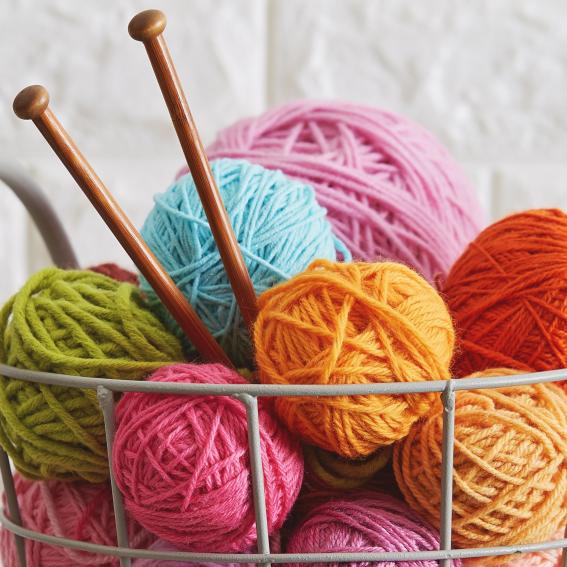 Colourful balls of yarn in a basket.