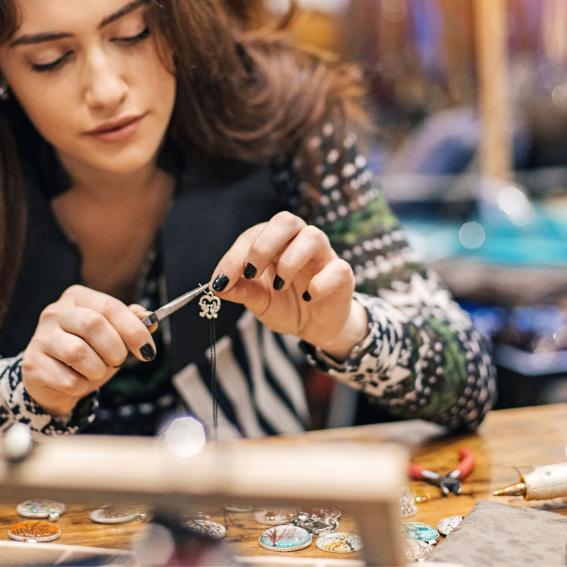 Young woman crafting jewelry.