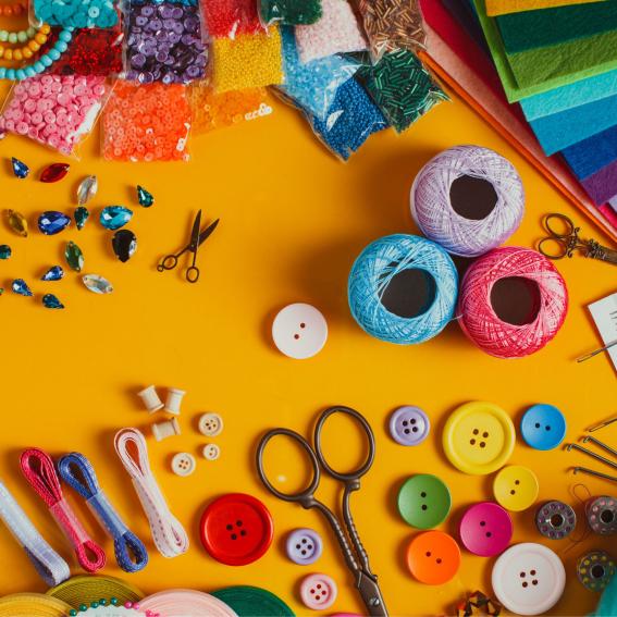 Colourful crafts on a yellow table.