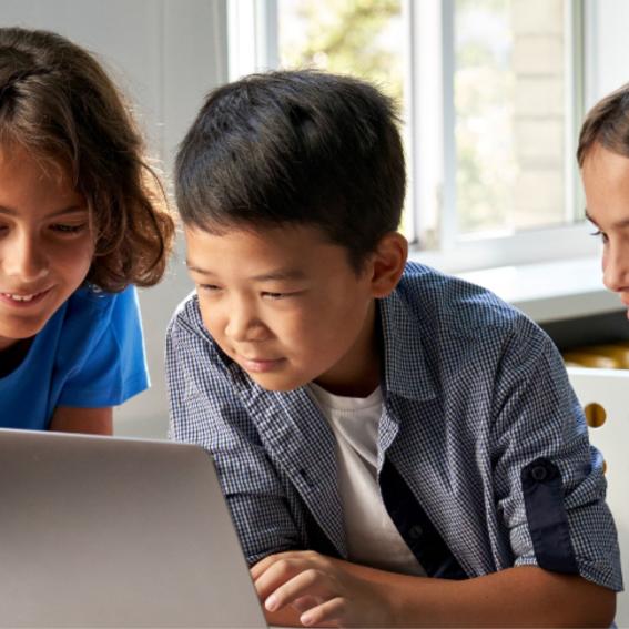 Children coding at a laptop.
