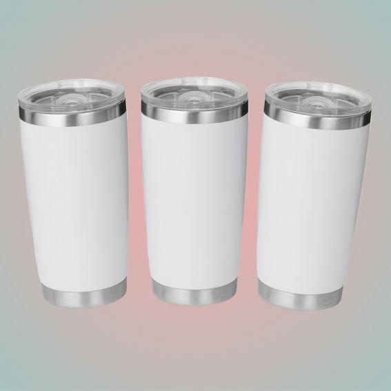 White travel mugs on a pink and blue background.