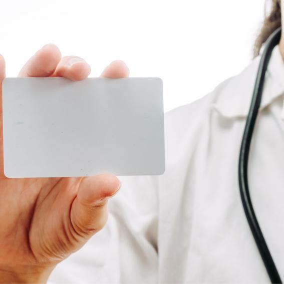 Doctor holding up a blank card.