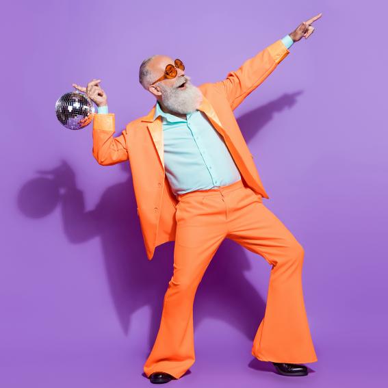 Man in bright orange suit dancing