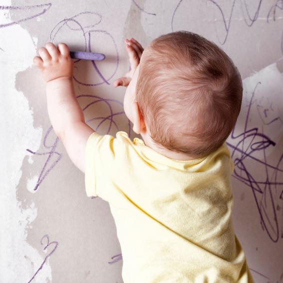 Baby drawing with crayons