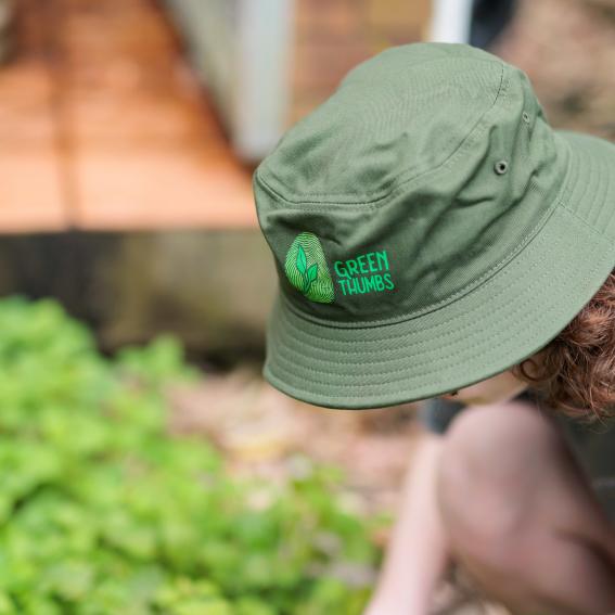 Young person in a Green thumbs bucket hat