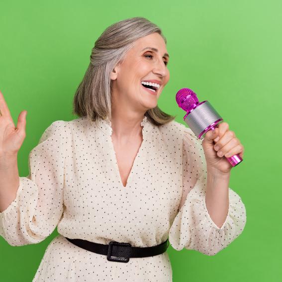 Lady singing into a microphone