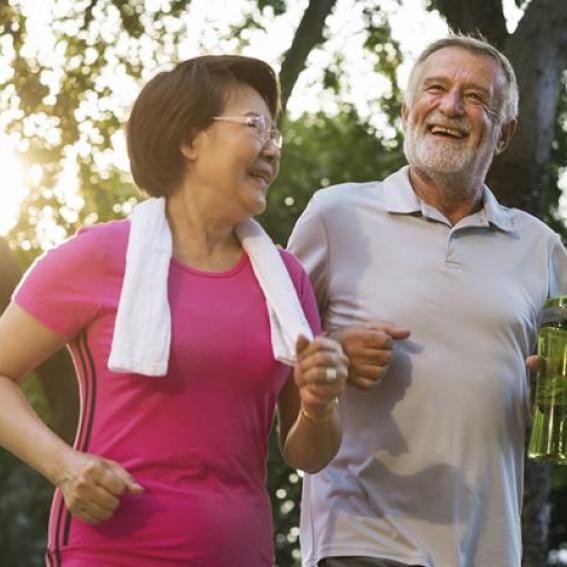 Senior male and female enjoying outdoor exercise