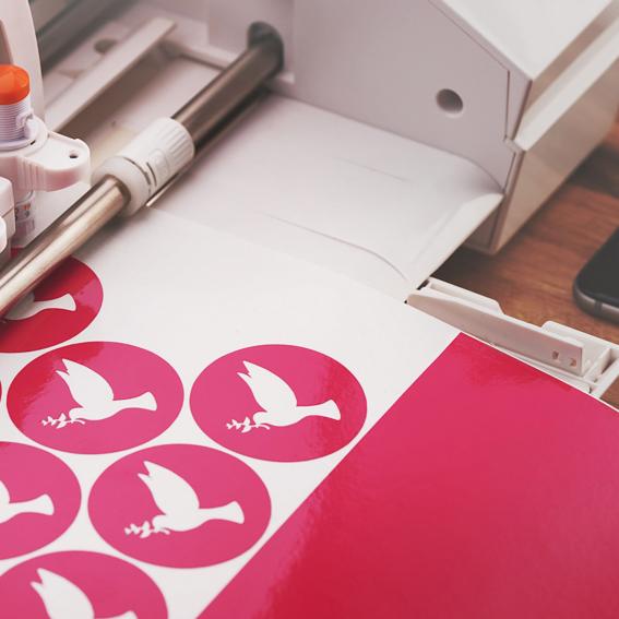 Cricut machine printing out bird stickers.