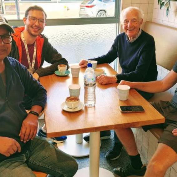 mans walking group having a coffee break