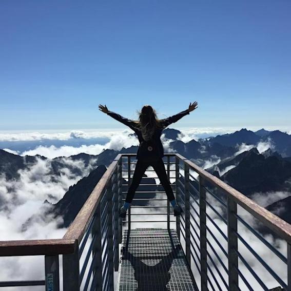 Person climbing a mountain top