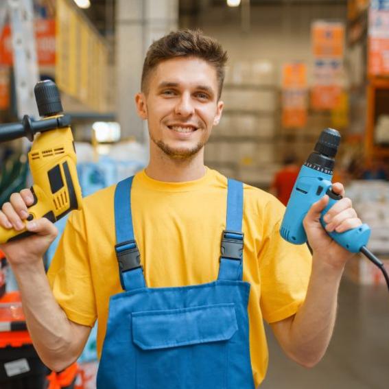 An image of a man holding tools