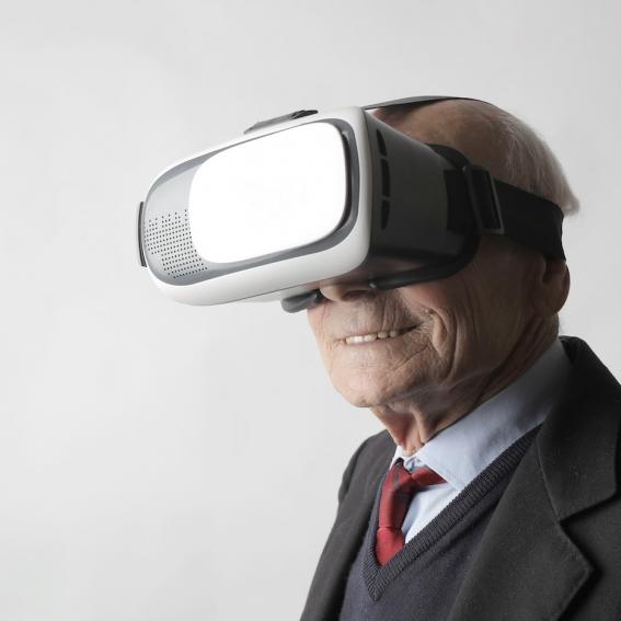 senior man in suit and tie wearing vr equipment