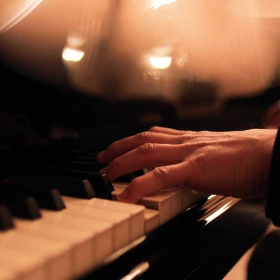hands on piano keyboard