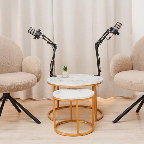 Two chairs with podcast microphones next to them.