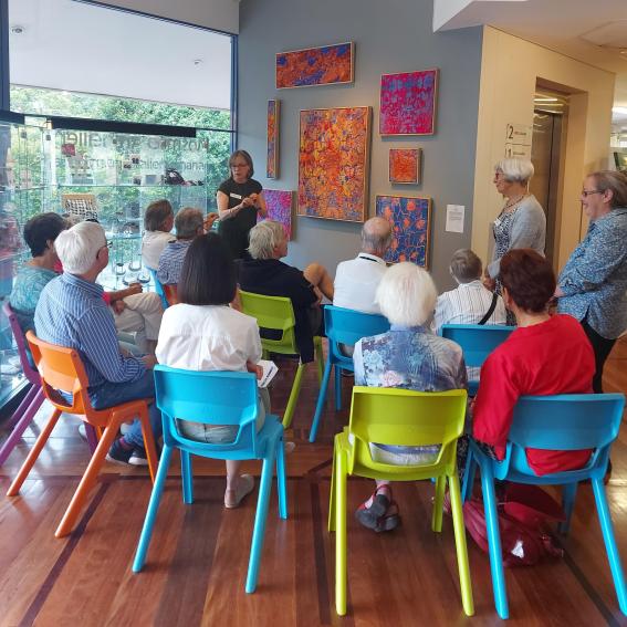 A group of people on an art gallery guided tour