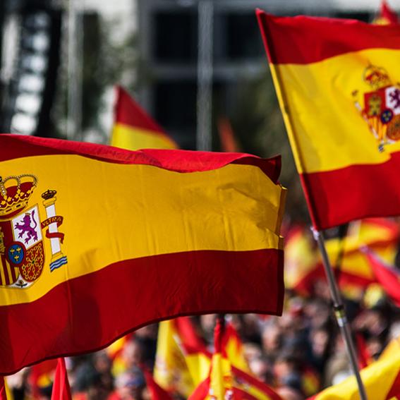 Spanish flags being waved in a crowd of people
