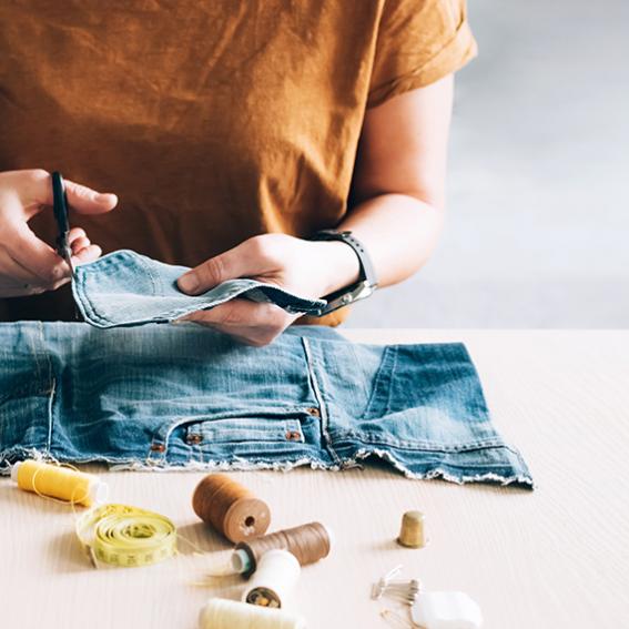 Woman repairing pocket of jeans