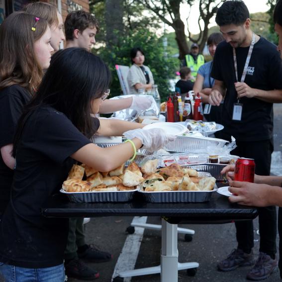 Young Volunteer handing out food at an event