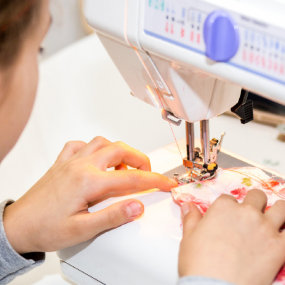 Young person sewing with machine