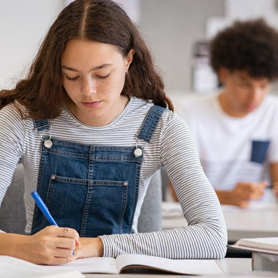 Young woman writing.