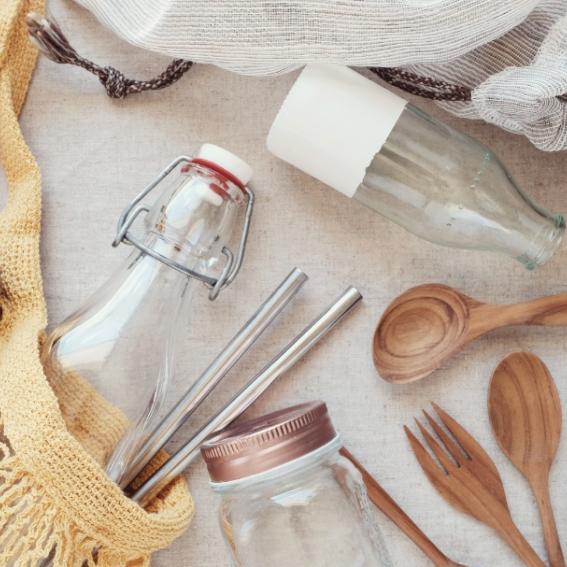 A collection of zero waste household items such as jars and spoons on a table.