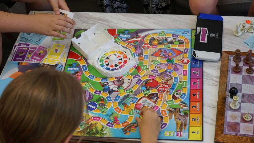 Some young people playing the Game of Life.