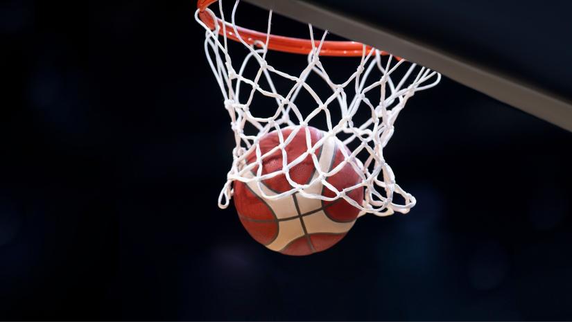 Basketball being shot through a basketball net.