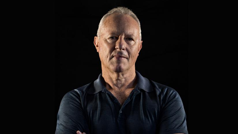 man in blue top facing camera