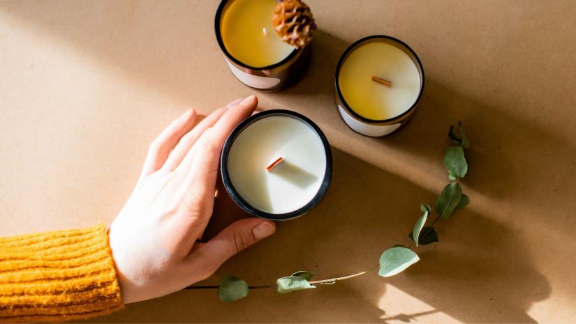 Three candles on a brown background.