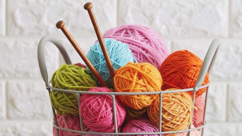 Colourful balls of yarn in a basket.