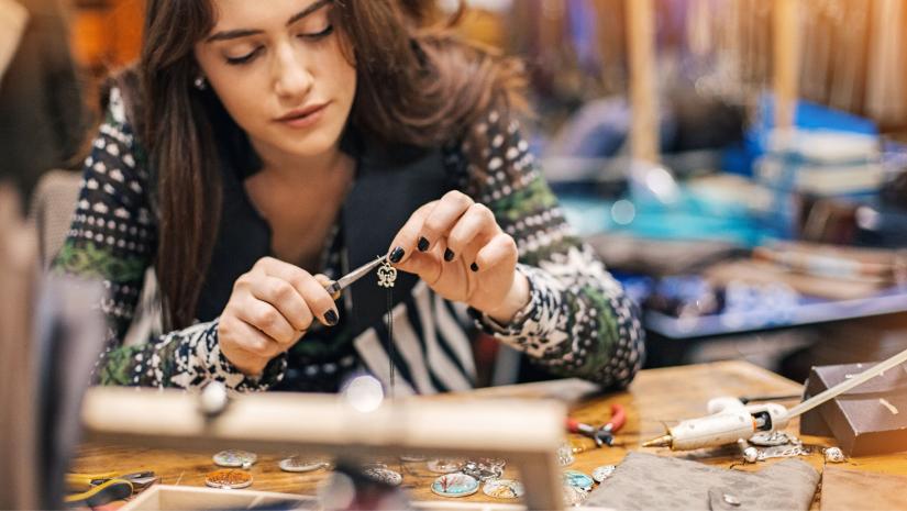 Young woman crafting jewelry.