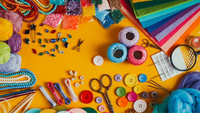 Colourful crafts on a yellow table.