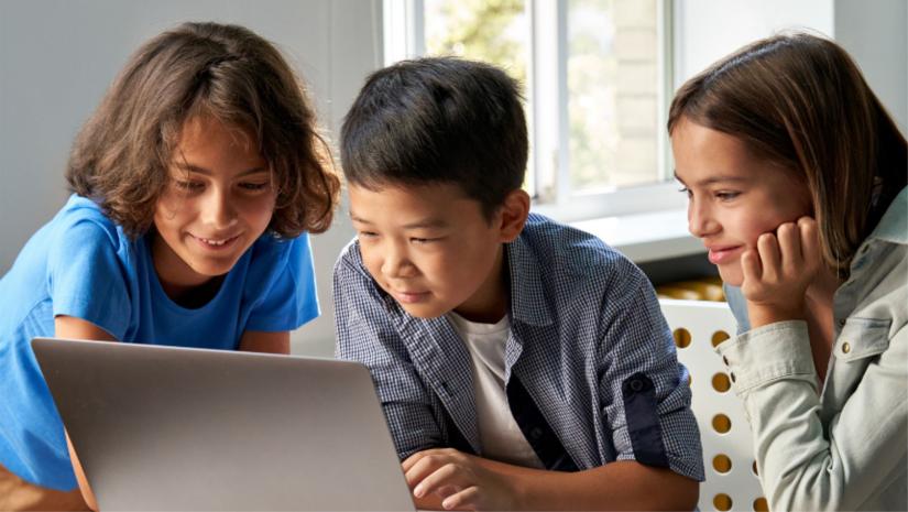 Children coding at a laptop.