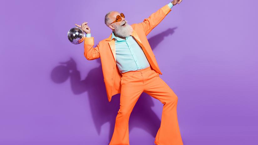 Man in bright orange suit dancing