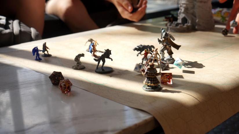 Dungeons and dragons figurines and dice mid campaign