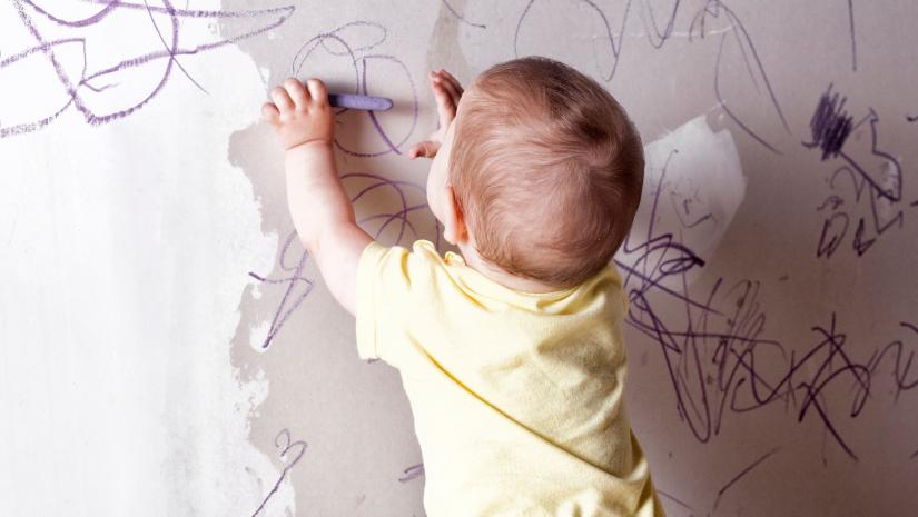 Baby drawing with crayons