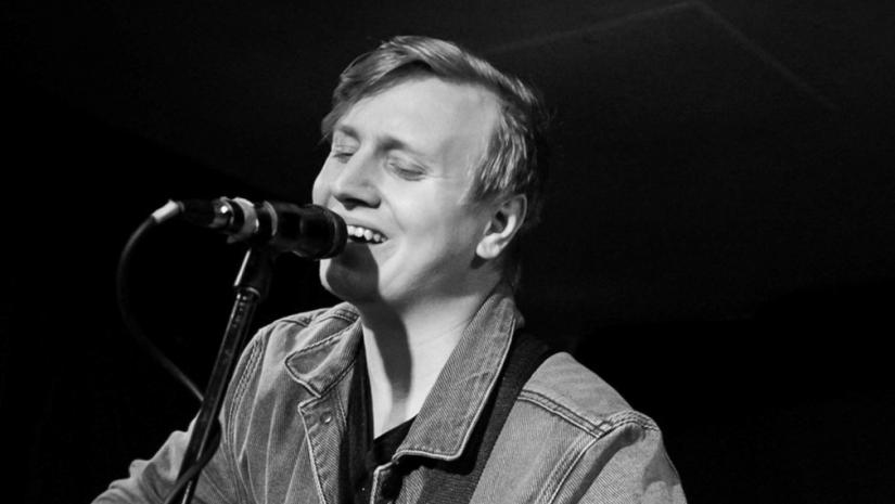 Photo of Karl Ernving singing into microphone