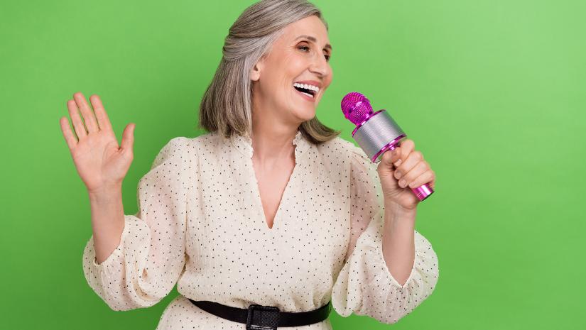 Lady singing into a microphone