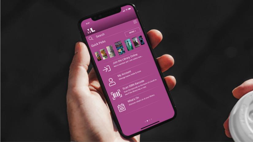 A person holding a phone with the MLS App.