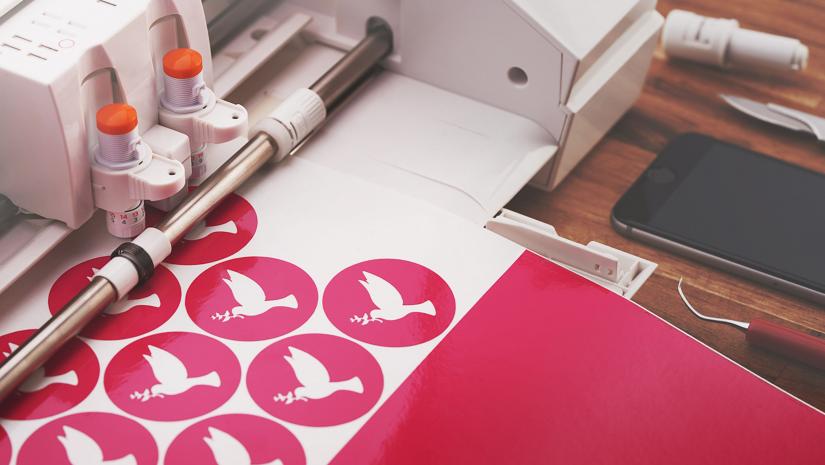 Cricut machine printing out bird stickers.