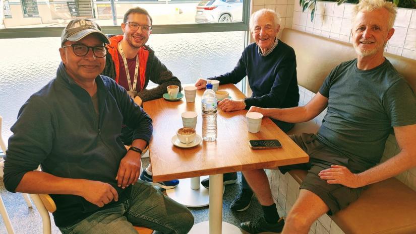 mans walking group having a coffee break