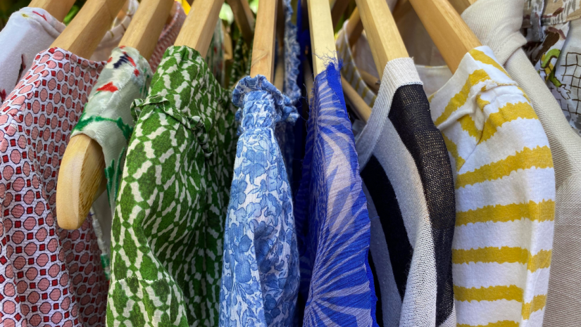 Mosman Charity Clothes Swap Beautiful cotton, silk and linen clothing hanging on wooden coat hangers